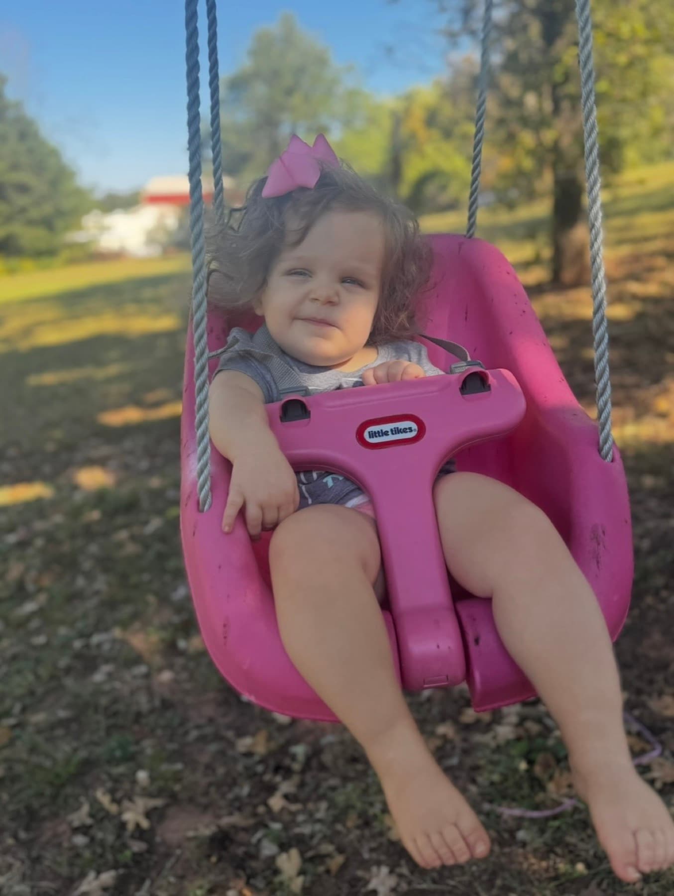 River enjoying time outside on her swing